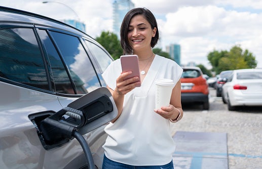 woman charging EV