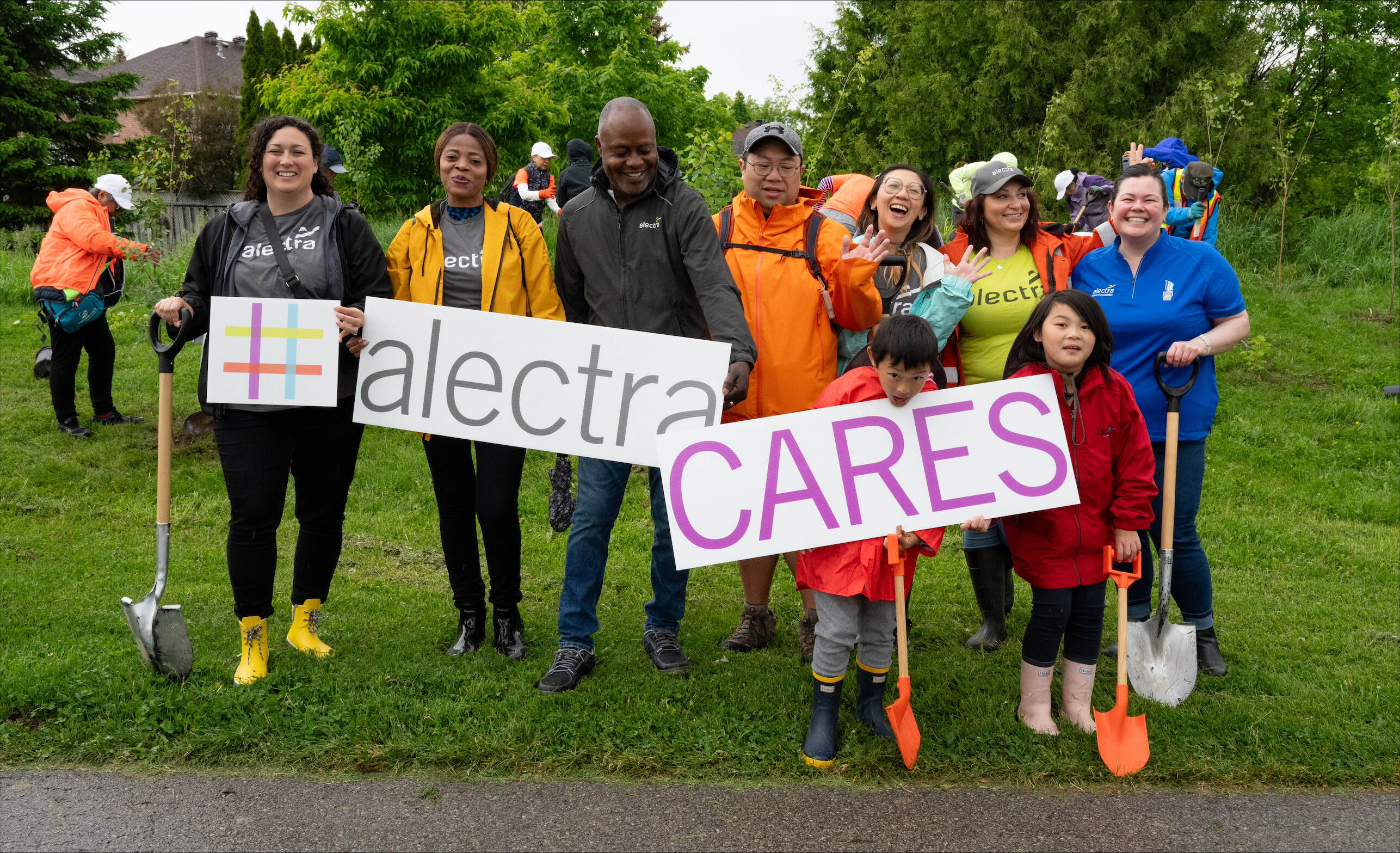 Group of people holding an Alectra Cares sign
